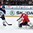 ZUG, SWITZERLAND - APRIL 25: Switzerland's Joren van Pottelberghe #30 makes a pad save while Finland's Petrus Palmu #15 looks on during semifinal round action at the 2015 IIHF Ice Hockey U18 World Championship. (Photo by Matt Zambonin/HHOF-IIHF Images)

